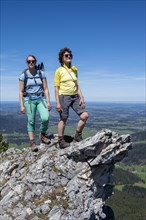 Two female hikers looking over the alpine foothills