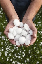 Golfball-sized hailstones in hands