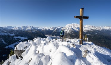 Hiker at the summit of the Jenner with summit cross