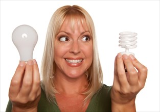 Woman holds energy saving and regular light bulbs isolated on a white background