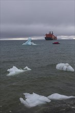 Icebreaker anchoring behind a iceberg
