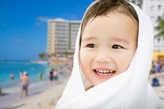Happy cute mixed-race chinese and caucasian boy on waikiki beach