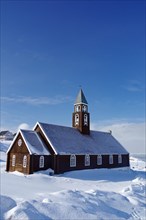 Wooden church in winter landscape