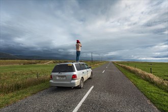 Guy with camera on car roof