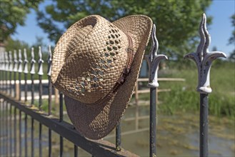 Straw hat on an old picket fence