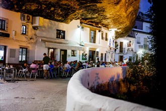 Tourist enjoying good food and drinks in the restaurants of Setenil de las Bodegas