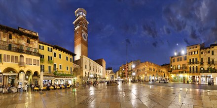 City square Piazza delle Erbe and former Roman Forum with fountain Fontana Madonna Verona and the medieval tower Torre dei Lamberti in the evening