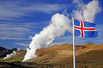 Icelandic flag in front of hot steam plumes
