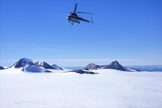 Helicopter flying over Brown Bluff in Antarctic Sound