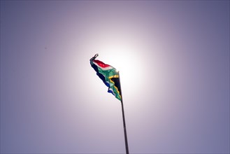 South African flag seen against sun background