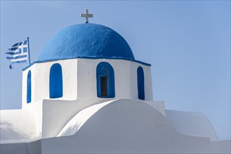 Blue roof of the Greek Orthodox Church Agios Konstantinos with Greek flag