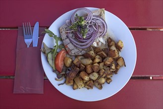 Brawn served with fried potatoes in a garden restaurant