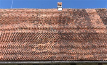 Roof with plain tiles on an old farmhouse from 1695