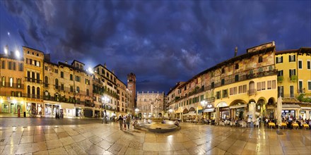 City square Piazza delle Erbe and former Roman Forum with fountain Fontana Madonna Verona in the evening