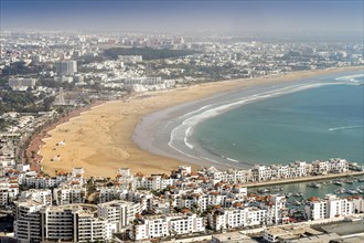 White modern architecture surrounding amazingly wide sandy beach in Agadir
