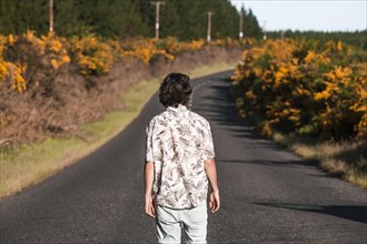 Guy walking on a road