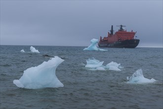 Icebreaker anchoring behind a iceberg