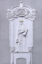 Art Nouveau relief of a woman with compasses on a residential house from 1908