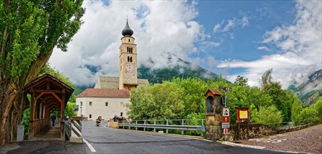 Parish church St. Pankraz with old Etsch wooden bridge