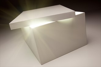 White box with lid revealing something very bright on a grey background