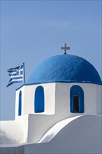 Blue and White Greek Orthodox Church Agios Nikolaos with Greek Flag
