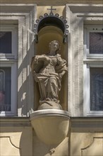 Sculpture of the Virgin Mary with canopy at a residential house