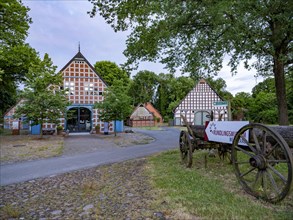 Old cart with sign to the Rundlingsmuseum Wendland (l.) in the Rundlingsdorf Luebeln