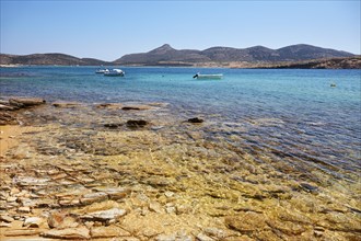Golden shimmering beach in Antiparos with view of Despotiko