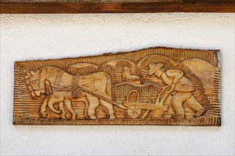 Wood carving on a house wall