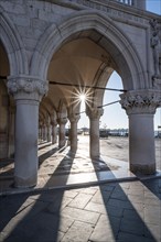 Sun shining through columns
