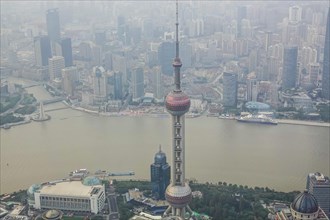 View from the highest observatory of the world on 562 meters height in the 632 meters high skyscraper Shanghai Tower on the special economic zone Pudong with the 468 meters high Oriental Pearl Tower t...