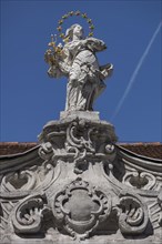 Mary sculpture with star wreath on a building