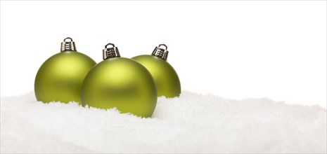 Three green christmas ornaments on snow flakes on a white background- great for a base image