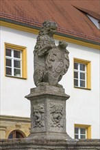 Lion with coat of arms as fountain figure in the castle courtyard