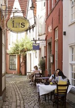 Outdoor restaurant in a small alley in the old town in the Schnoor or Schnoorviertel