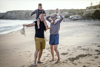 The family with two small boys enjoying the beach