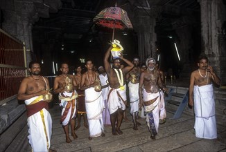 Priests carrying kalasa on the temple corridor during Ganesh festival in karpaga Vinayagar temple at Pillaiyarpatti