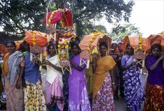 Women devotees carrying Kavadi on their shoulders to Palani on Thai Poosam day
