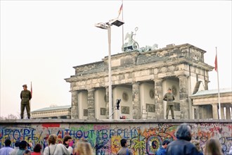 Wall in front of the Brandenburg Gate monitored by two People's Police officers and a camera