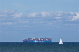 Container ship and sailing boat off Puttgarden