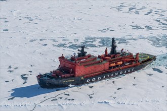 Aerial of the Icebreaker '50 years of victory' on its way to the North Pole breaking through the ice