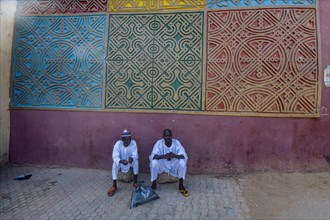 Men sitting at the entrance to Gidan Rumfa