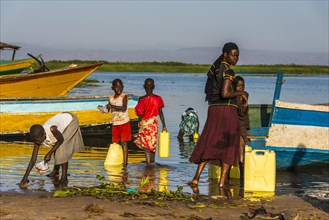 Children filling water in canisters at Lake Albert