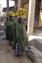 Women carrying fruits on their head
