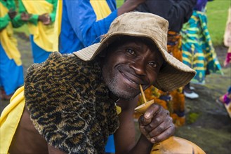Friendly man drinking local beer at a Ceremony of former poachers