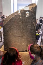 Visitors looking at the Rosetta Stone
