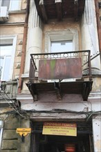 House facade in need of renovation with balloons in Panteleimonivska Street