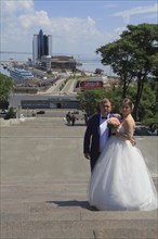 Potemkin stairs and passenger terminal in the harbour with wedding couple