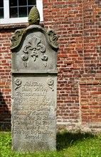 Historic sandstone gravestone from the 18th century in the churchyard of St. Nicholas Church