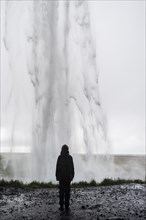 Girl watching waterfall